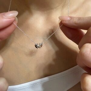 “Steps of Love: Baby Feet Medal Necklace for a Cherished Memory”